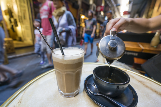 Enjoying coffee and tea at a cafe in a laneway